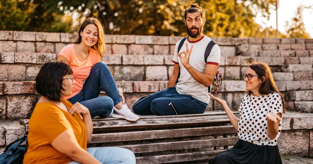 Deaf and hard of hearing people signing ASL outdoors.